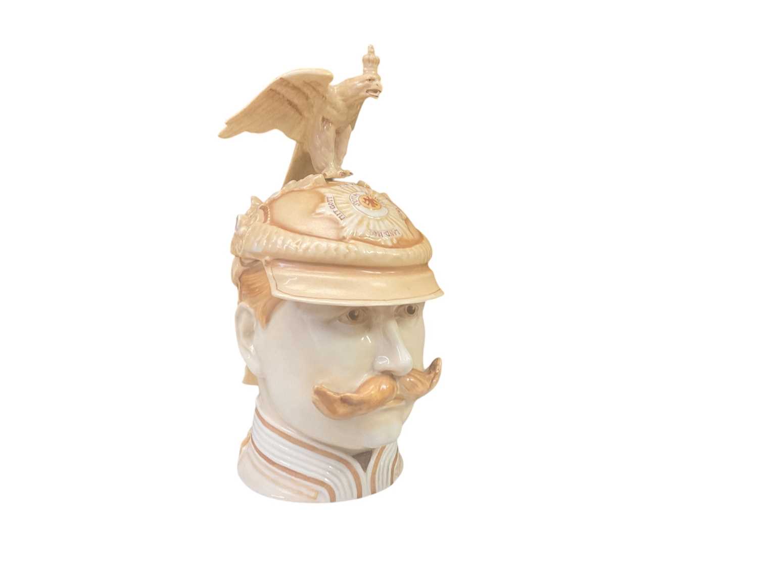 Lot 819 - Impressive Imperial German porcelain stein in the form of Kaiser Wilhelm II wearing a Garde du Corps helmet, the hinged cover with metal mount and ornate thumb piece with cross and laurel wreath...