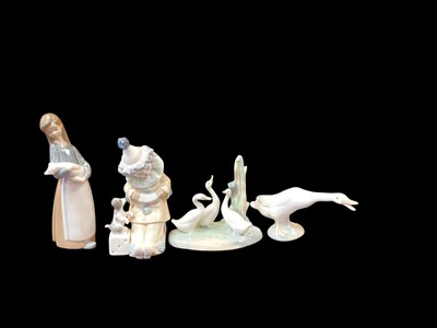 Lot 1257 - Four Lladro porcelain figures together with a Nao figure