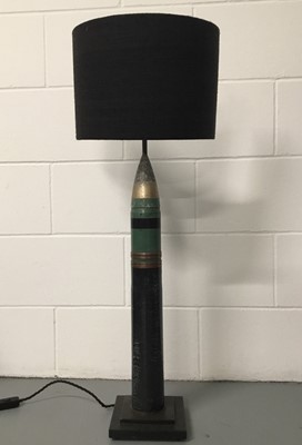 Lot 21 - Missile lamp with half shade, 95cm with shade, 77cm without shade, on 18cm square base. Missile 63cm.