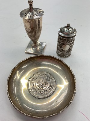 Lot 1102 - Two late 19th/early 20th century Chinese silver pepper pots, together with a Hong Kong silver dish. (3)