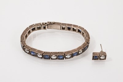 Lot 237 - Indian blue and white sapphire alternating tennis bracelet in a white metal setting, 17cm long, together with one matching stud earring