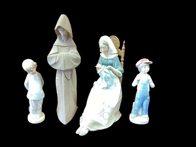 Lot 1253 - Four Lladro porcelain figures including woman embroidering and praying monk