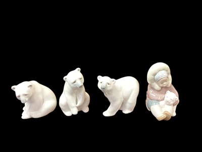 Lot 1258 - Three Lladro porcelain polar bears, together with an Eskimo with a polar bear (all boxed)