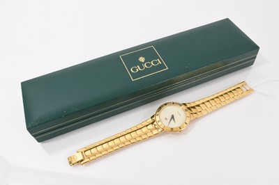 Lot 255 - Gucci gold plated wristwatch with mother of pearl dial, in a green Gucci box