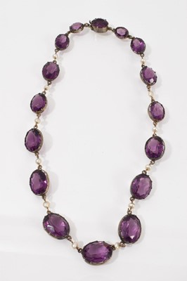 Lot 268 - Amethyst rivière necklace with sixteen graduated oval mixed cut amethysts in a white metal collet setting interspaced with seed pearls, 38cm long