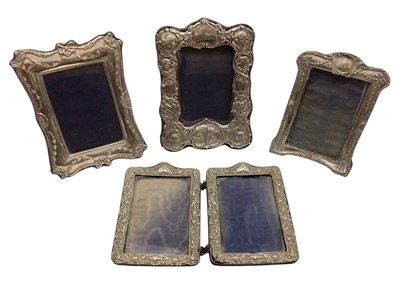 Lot 285 - Four Edwardian and later silver photograph frames all with embossed scroll decoration