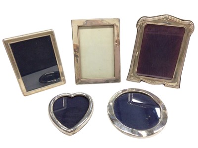 Lot 286 - Five silver photograph frames to include three rectangular, one round and one heart shaped, various dates and makers