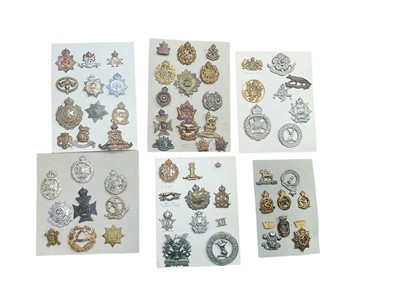 Lot 774 - Group of six boards mounted with a selection of British Military cap badges to include Lancashire Hussars, Royal Flying Corps, RAF and National Fire Service.