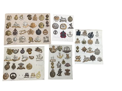 Lot 776 - Group of five boards mounted with a selection of British Military cap badges to include RAF, Artists Rifles and Essex Regiment.