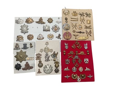 Lot 780 - Group of five boards mounted with a selection of British Military cap badges to include ATS, Essex Regiment and Cameron Highlanders.