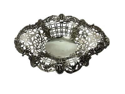 Lot 180 - Victorian silver bon bon dish of oval form, with pierced decoration and flared rim, on a cast base (London 1896), 11.2 ozs. 23.5cm across