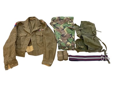 Lot 796 - Group of assorted British Army uniform to include a 1949 pattern battle dress blouse, dated 1950, canvas webbing belts, stable belts and others.