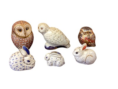 Lot 1277 - Three Royal Crown Derby owl paperweights including Snowy Owl, together with three rabbits (6)