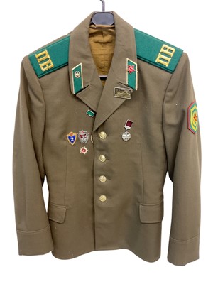 Lot 890 - Cold War era Soviet military jacket with badges and insignia.