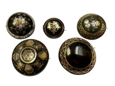 Lot 218 - Group of five 19th century tortoishell piqué work brooches with floral decoration. 20-31mm diameter