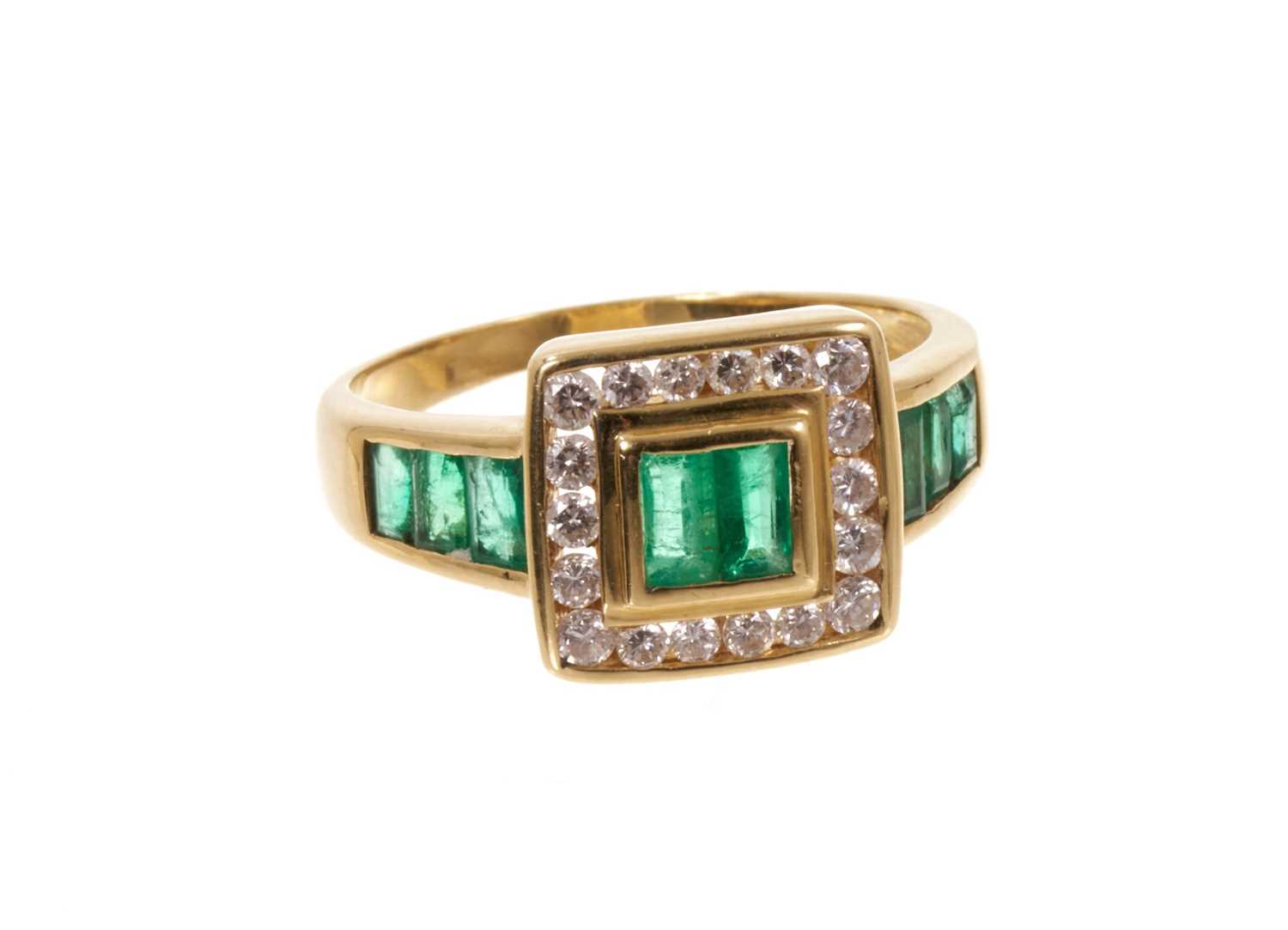 Lot 665 - Emerald and diamond ring with step cut emeralds and a square border of brilliant cut diamonds flanked by further emeralds to the shoulders on 18ct gold shank