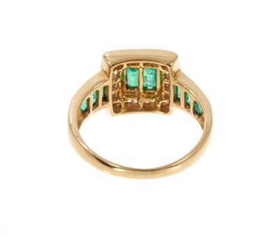 Lot 665 - Emerald and diamond ring with step cut emeralds and a square border of brilliant cut diamonds flanked by further emeralds to the shoulders on 18ct gold shank