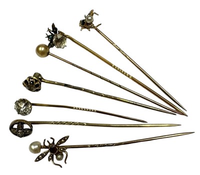 Lot 234 - Seven antique stick pins to include three gold and gem-set novelty insect stick pins