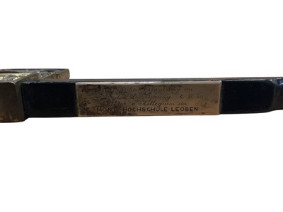 Lot 2549 - German Miner’s Guild hatchet cane from 1946, with Ebonised shaft, mounted with a symbolic, gilt metal miner’s hatchet handle and engraved presentation plaque “Fur freundlichen Erinnerung an der...