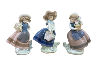 Lot 1285 - Three Lladro porcelain figures of young girls with flowers