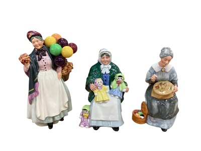 Lot 1287 - Three Royal Doulton figures - Biddy Pennyfarthing HN1843, The Rag Doll Seller HN2944 and Embroidering HN2855