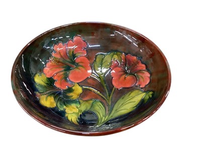 Lot 1288 - Early 20th century Moorcroft pottery bowl decorated in the Hibiscus patten, impressed marks and painted signature to base, 23.5 cm diameter