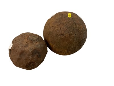 Lot 922 - Large antique iron cannon ball, together with another smaller cannon ball, the largest approx. 20cm in height (2).