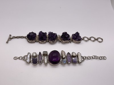 Lot 252 - Two silver and amethyst bracelets, one with a large central cabochon amethyst, moonstones and freshwater cultured keshi pearls, 19.5cm, and an amethyst geode bracelet in silver setting, 21cm (2)...