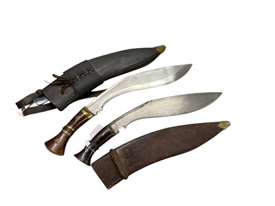 Lot 1020 - Large old Nepalese Kukri with crescent moon stamped on blade in leather covered sheath, blade 33cm in length, together with a replica British military issue Kukri, blade 33cm in length (2)