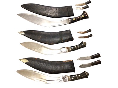 Lot 1021 - Group of three old Gurkha Kukri's in leather covered sheaths