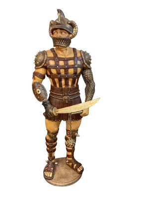 Lot 936 - Large free standing fibreglass display model of a Gladiator in uniform bearing his weapons, 189cm in overall height.