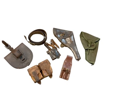 Lot 943 - Second World War brown leather service revolver holster, a canvas webbing holster, two leather frogs and other leather pouches.