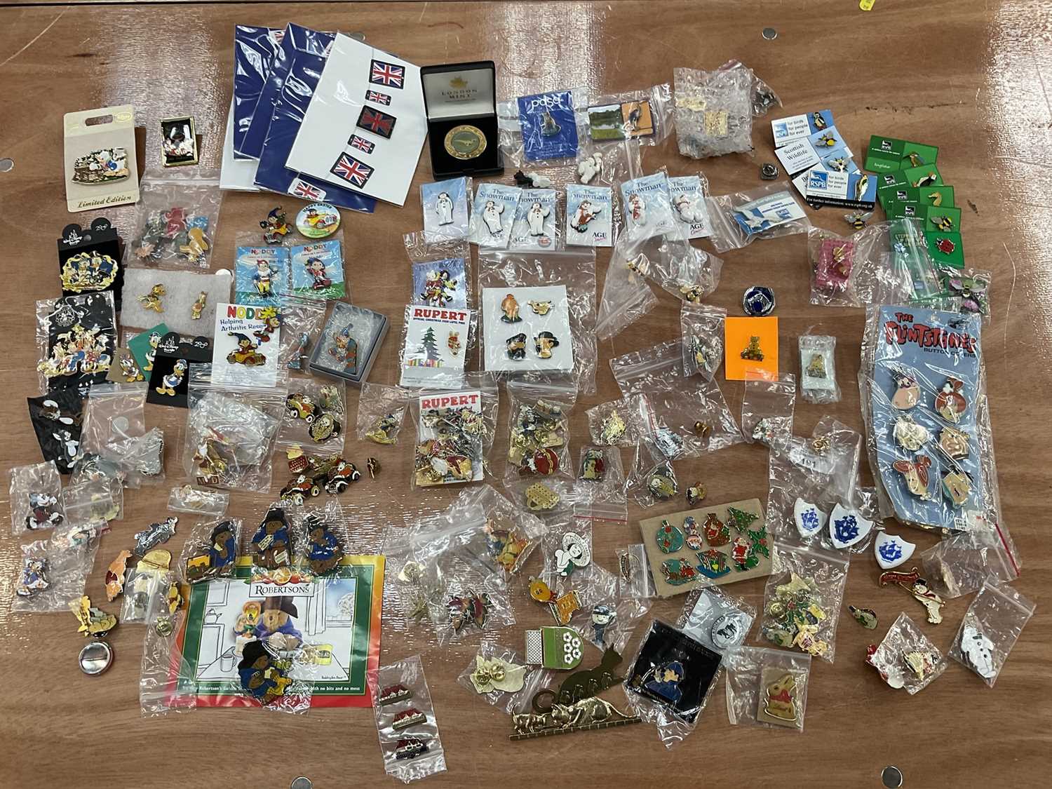 Lot 2603 - Collection of enamel bagels and pins including Blue Peter, Noddy, Flintstones, Tin Tin, Disney, Paddington, Rupert The Bear, etc