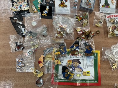 Lot 2603 - Collection of enamel bagels and pins including Blue Peter, Noddy, Flintstones, Tin Tin, Disney, Paddington, Rupert The Bear, etc
