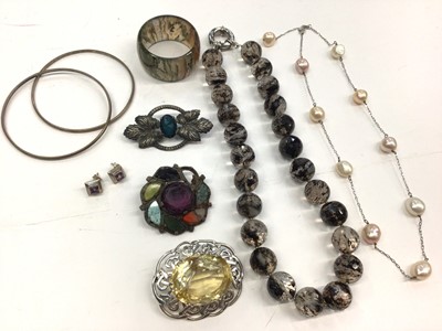 Lot 299 - Large Scottish silver and citrine brooch, agate bead necklace, agate napkin ring, silver and cultured pearl necklace, two bangles etc