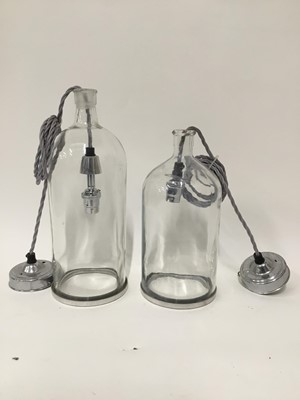 Lot 165 - Two glass bottle hanging lanterns with grey cord fittings, 34cm and 28cm