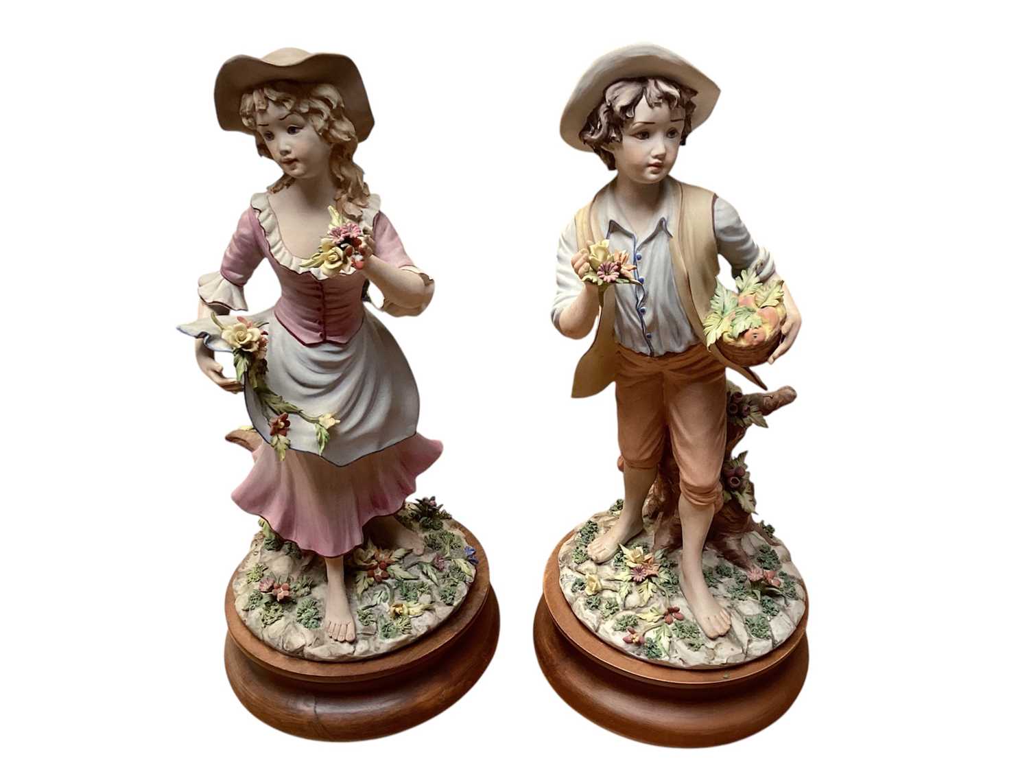 Lot 1336 - Collection of 7 Capodimonte figures including seated couple picking flowers, boy with basket of fruit, girl playing a musical instrument etc (some signed) together with two small figures and two...