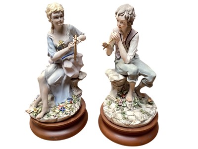 Lot 1336 - Collection of 7 Capodimonte figures including seated couple picking flowers, boy with basket of fruit, girl playing a musical instrument etc (some signed) together with two small figures and two...
