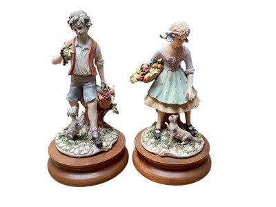 Lot 1336 - Collection of 7 Capodimonte figures including seated couple picking flowers, boy with basket of fruit, girl playing a musical instrument etc (some signed) together with two small figures and two...