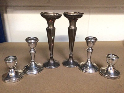 Lot 1019 - Pair of silver spill vases, together with two pairs of silver candlesticks, various sizes