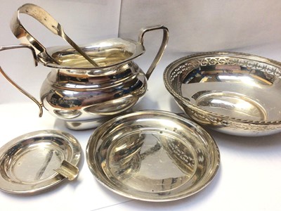 Lot 1022 - Silver two handled sugar bowl, pair of silver sugar tongs, pierced silver bowl, silver dish and a small silver ashtray (5)