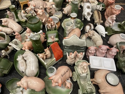 Lot 147 - A porkticularly good collection of Continental ceramic pig ornaments