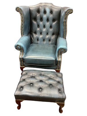 Lot 1201 - Leather wing back chair and footstool