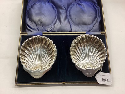 Lot 1063 - Pair of silver shell shaped butter dishes in case and a set of twelve silver handled dessert knives and forks in fitted case