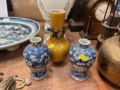 Lot 456 - Pair of Chinese prunus vases on crushed ice ground together with another Chinese vase (3).