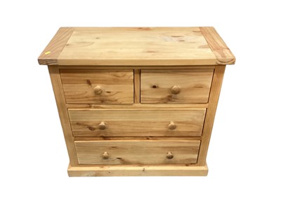 Lot 1210 - Modern pine chest of two short and two long drawers, 80cm wide, 38cm deep, 74cm high, together with a matching three drawer bedside chest, 45cm wide, 35cm deep, 67.5cm high (2)