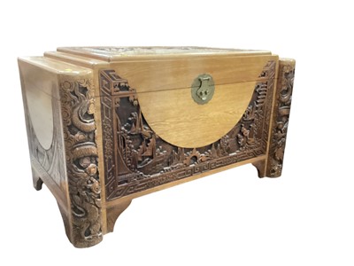 Lot 1303 - Chinese carved camphor wood chest, together with a similar carved table (2)