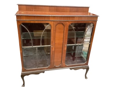 Lot 1215 - Mahogany display cabinet with ledge back, glass shelves enclosed by two glazed doors on cabriole legs, 121cm wide, 34.5cm deep, 134cm high