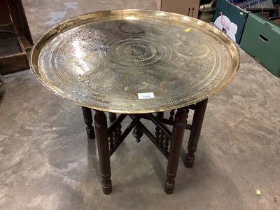 Lot 1245 - Indian Benares brass circular coffee table on folding wooden stand