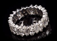 Lot 664 - Diamond full band eternity ring with baguette...